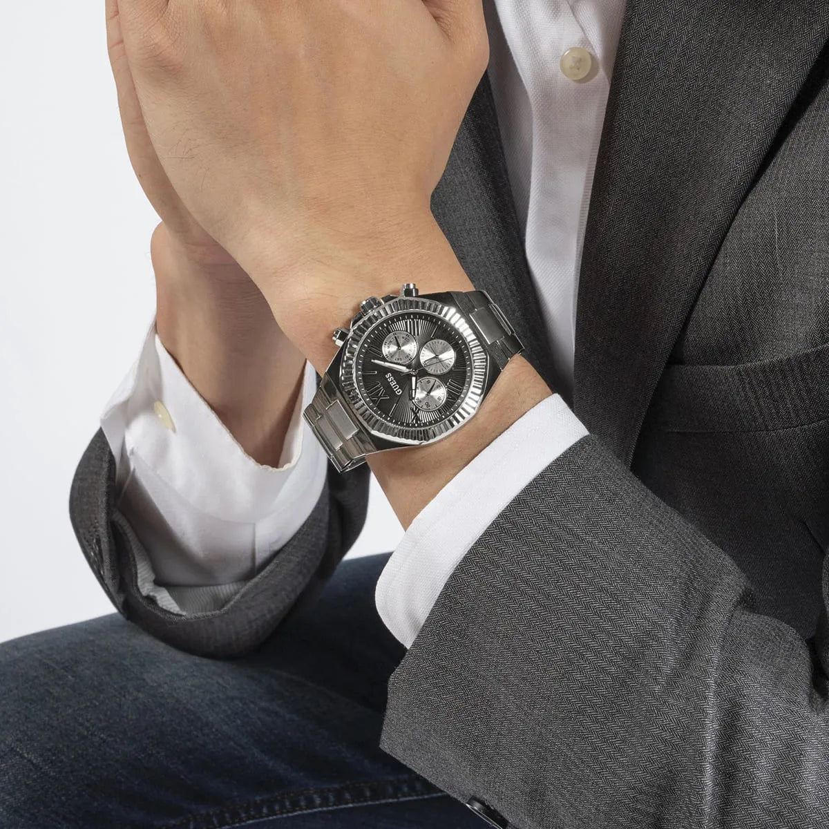 GUESS Equity GW0703G1 chronograph watch on wrist showing black dial and Roman numerals