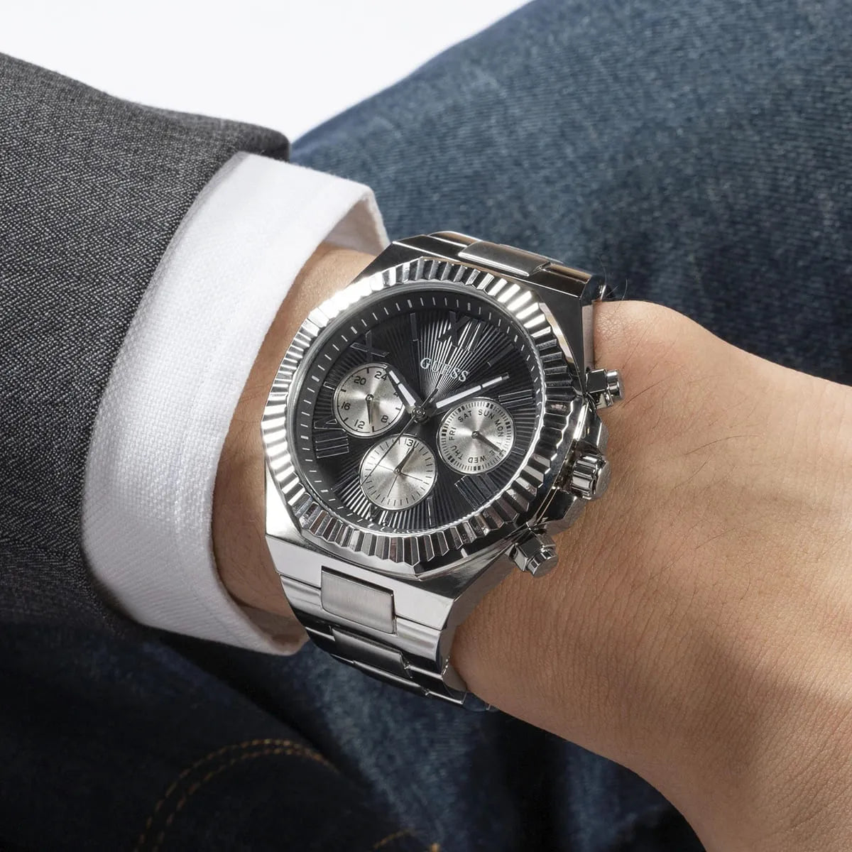 GUESS Equity mens watch on wrist displaying chronograph subdials and fluted bezel