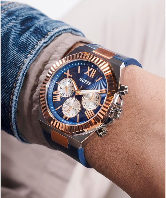 Guess Equity chronograph on wrist displaying blue dial with gold bezel and navy strap