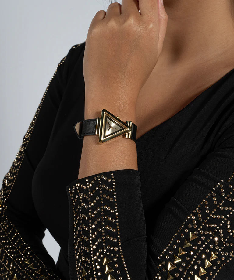 Guess Fame GW0548L3 women's watch worn on wrist with gold case and black strap