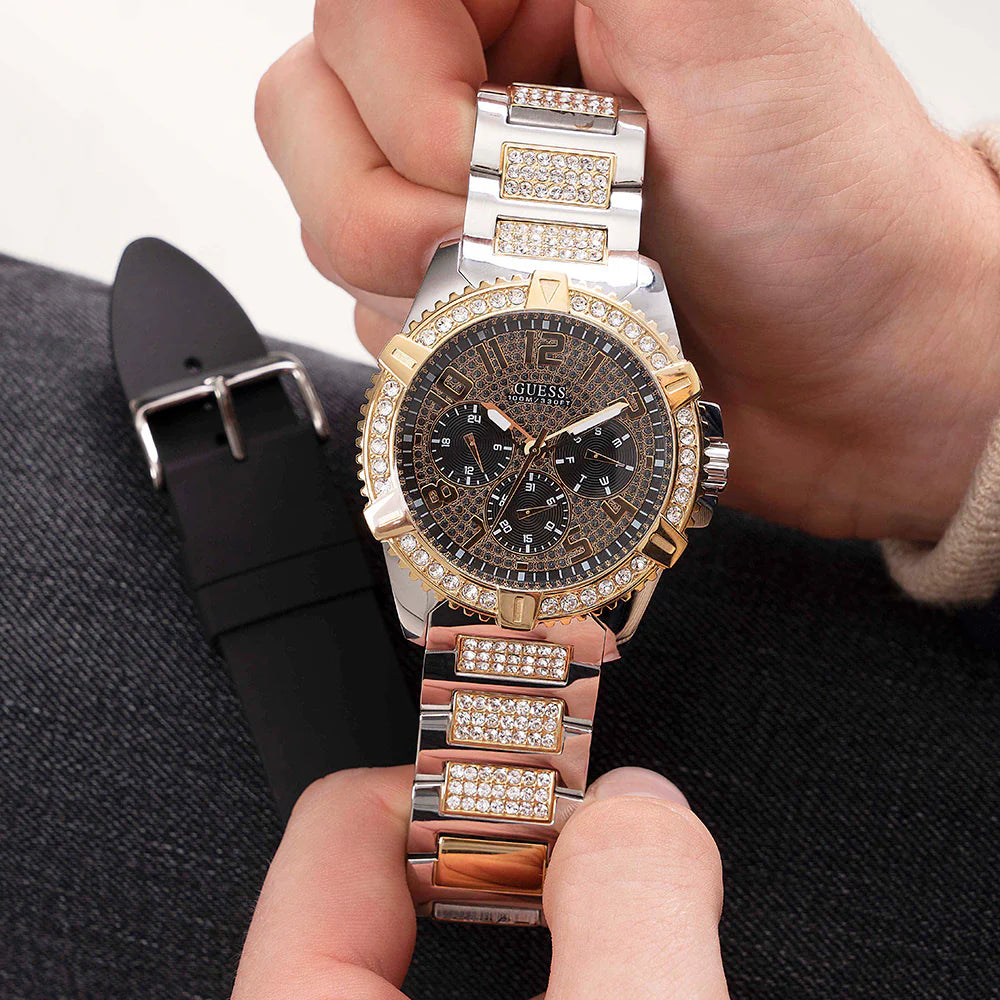 Guess Frontier chronograph watch held in hand showing dial and metal bracelet