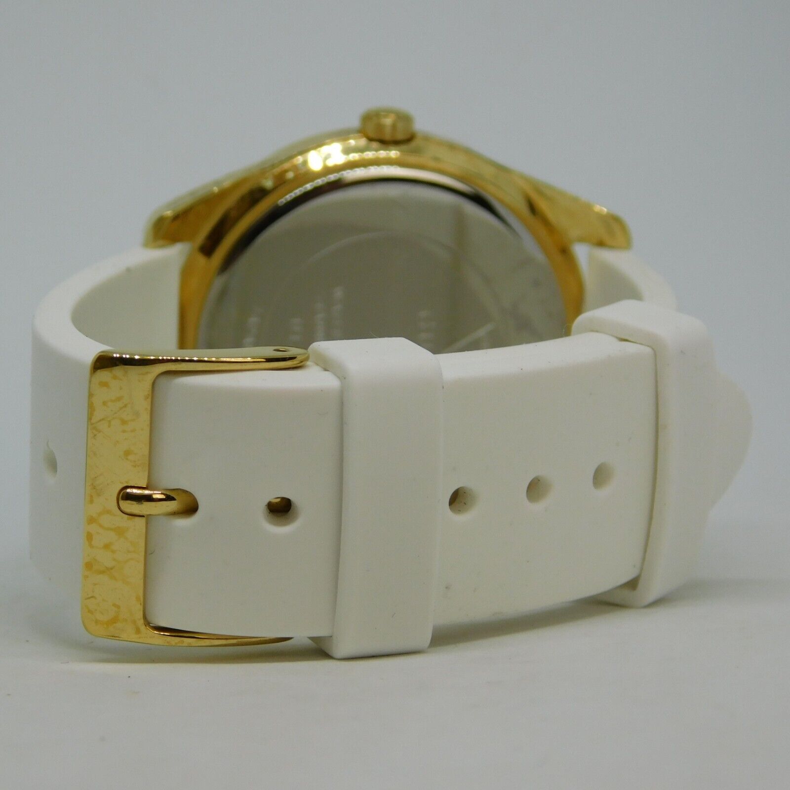 White silicone strap with gold buckle closure on Guess G Twist watch