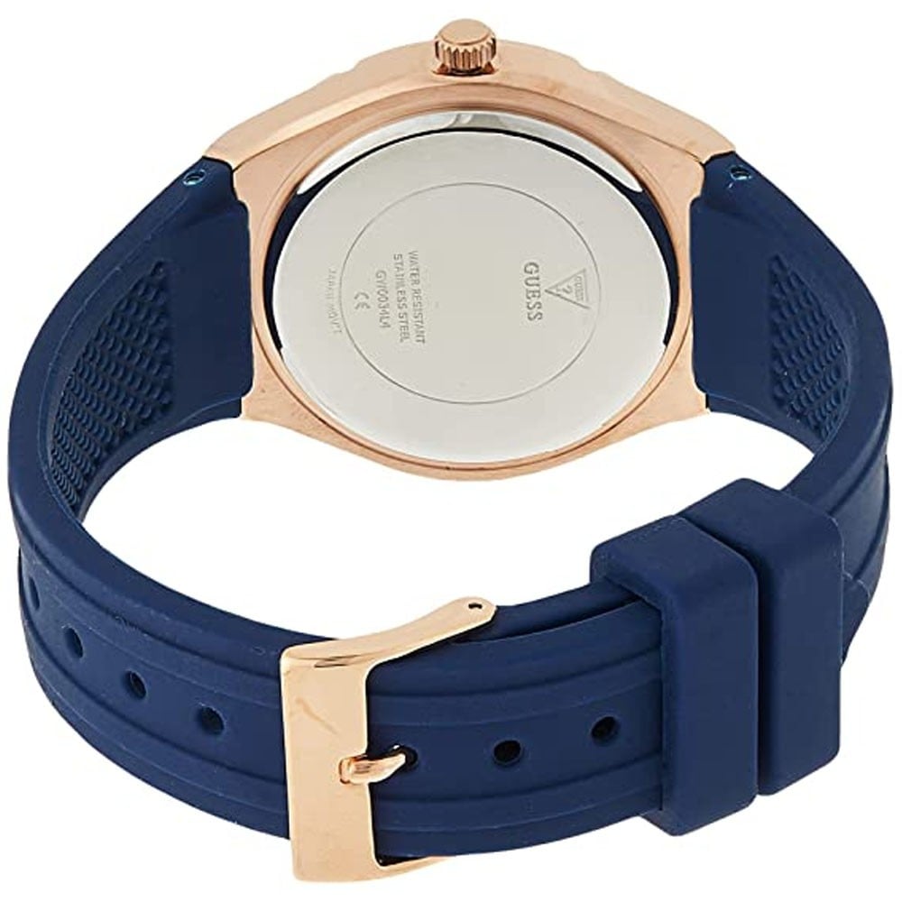 Silver caseback of Guess watch with rose gold case and blue silicone strap