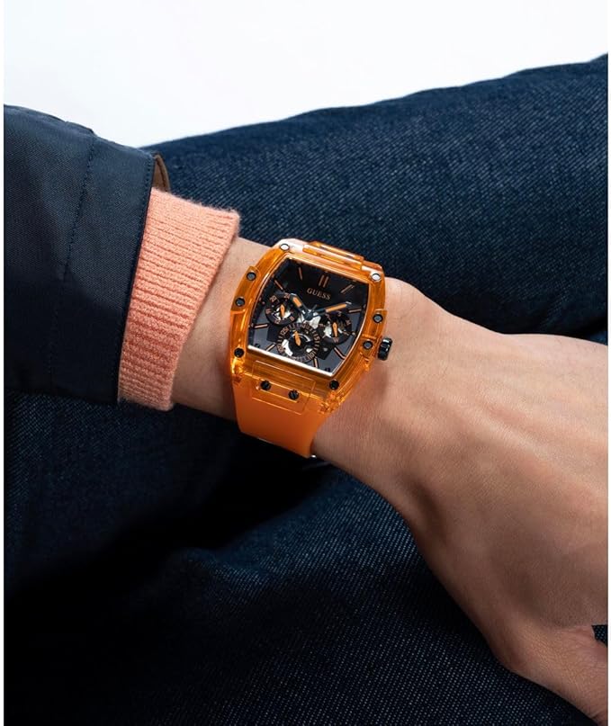 GUESS GW0203G1 wristwatch on wrist showing orange case and black dial