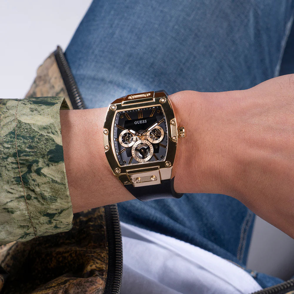 GUESS GW0203G8 black multi-function watch worn on wrist with denim shirt