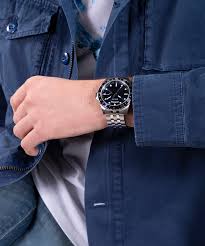 GUESS GW0220G1 silver tone watch worn on wrist with blue dial visible