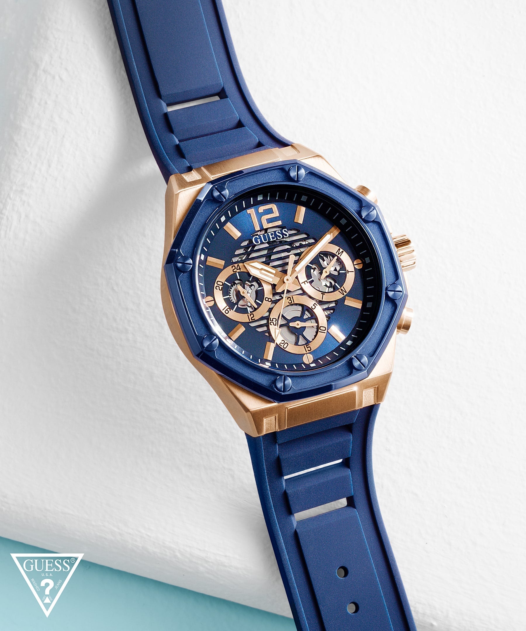Guess GW0263G2 watch on wrist displaying blue dial with rose gold chronograph subdials