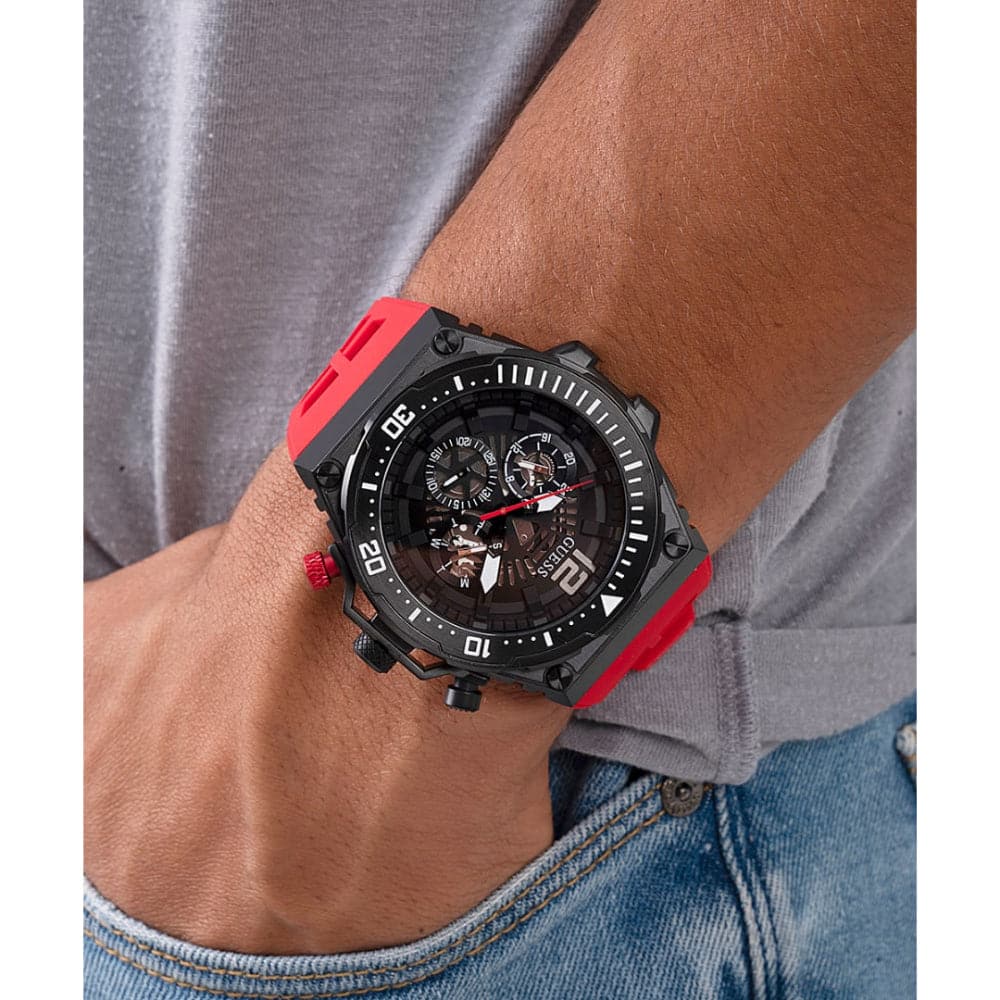 Guess GW0325G3 watch worn on wrist showing black dial and red rubber strap