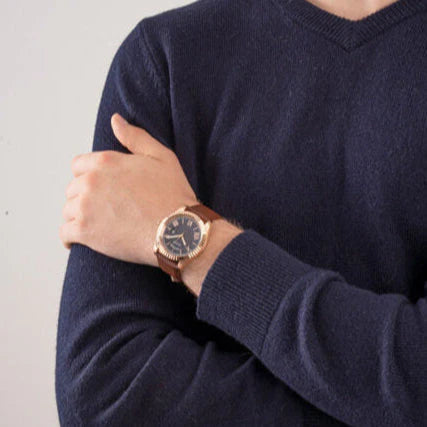 Guess GW0353G2 watch worn on wrist with rose gold case and brown leather strap