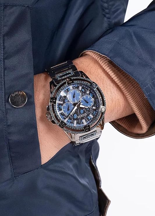 GUESS GW0497G5 gunmetal chronograph watch on wrist showing blue dial and diamond bezel detail