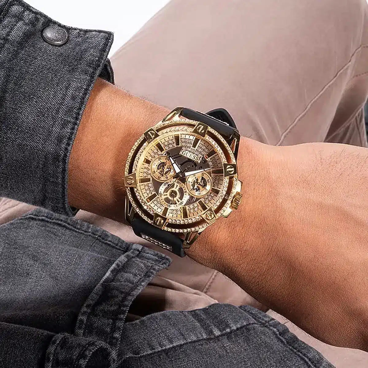 Guess GW0536L3 champagne dial watch worn on wrist, styled with casual denim and blush top