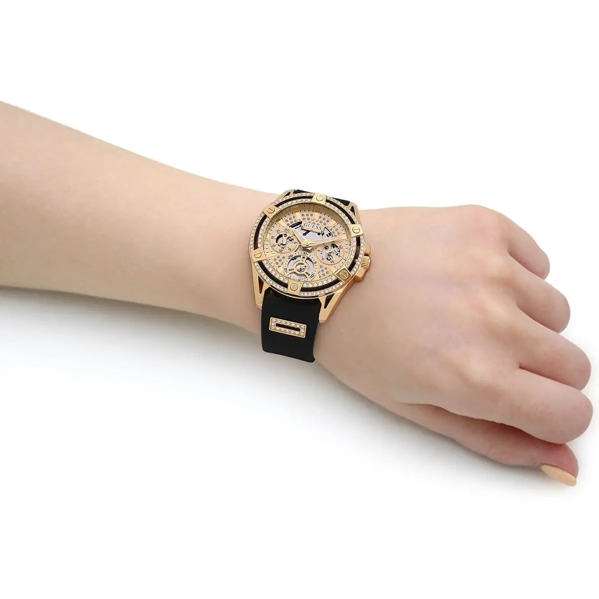 Guess GW0536L3 women's watch worn on wrist showing gold case and black rubber strap