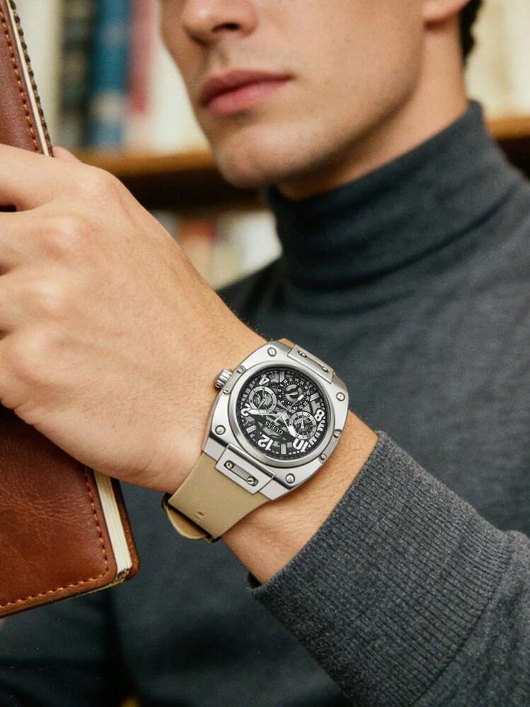 Guess GW0569G1 watch on wrist with tan strap and skeleton dial display