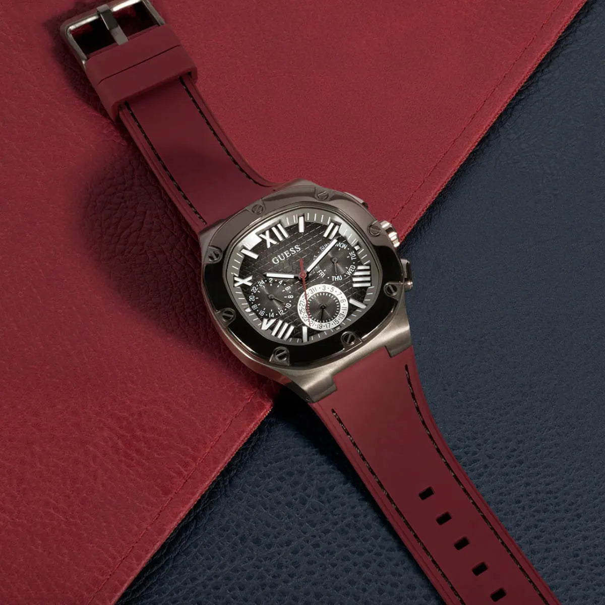 GUESS GW0571G4 watch flat lay on contrasting fabric backgrounds