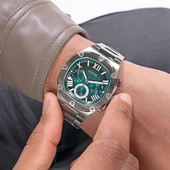 GUESS GW0572G6 chronograph watch worn on wrist, silver case with teal dial
