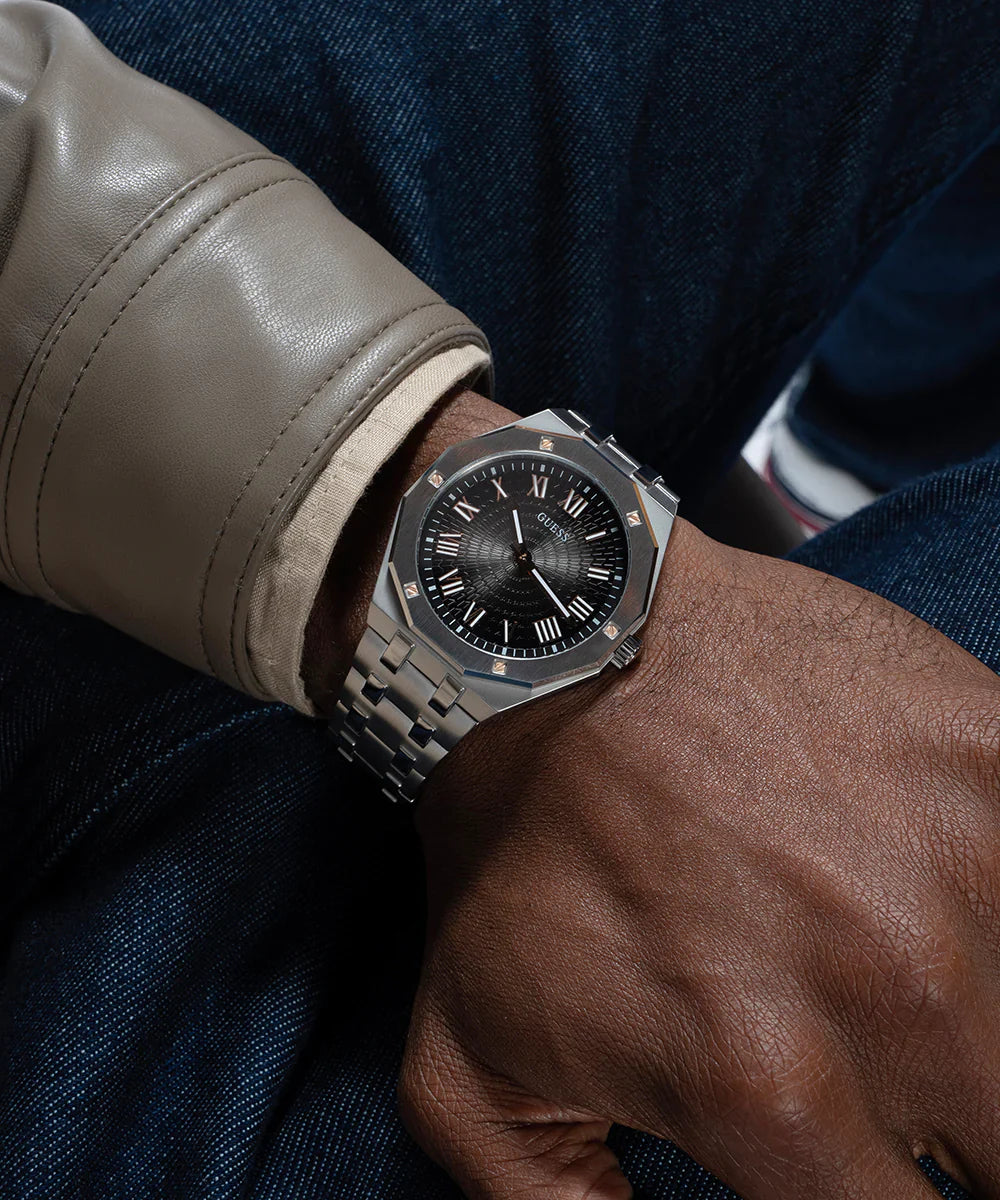Guess GW0575G1 watch worn on wrist with black dial and silver bracelet