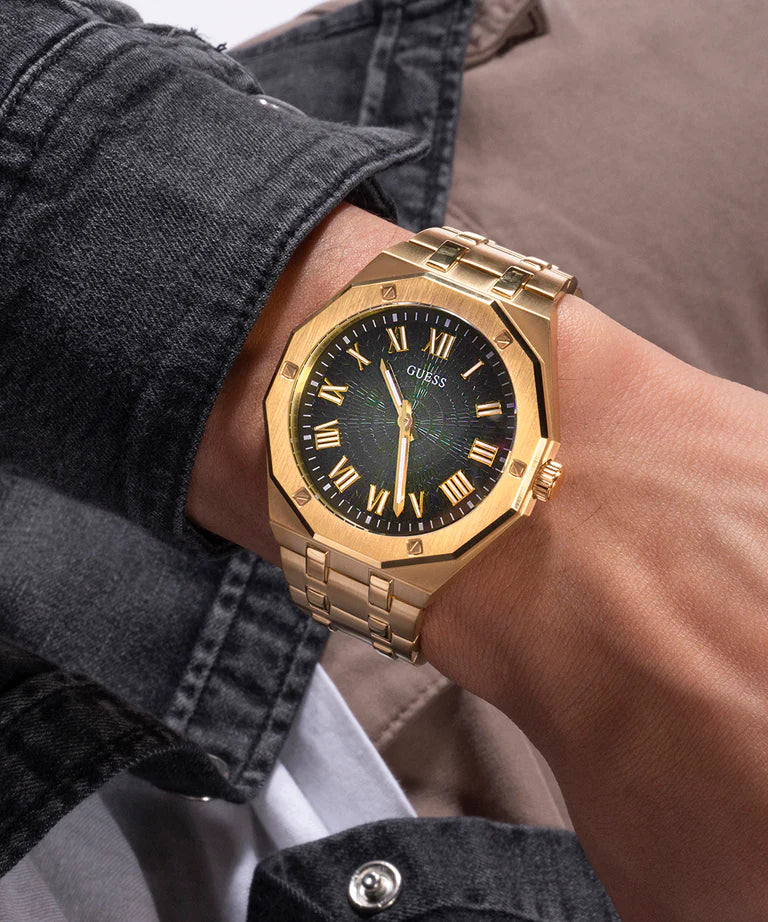 GUESS gold watch with black dial worn on wrist showing side profile