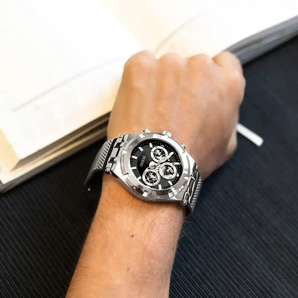 Guess GW0582G1 men's chronograph watch worn on wrist with silver mesh strap