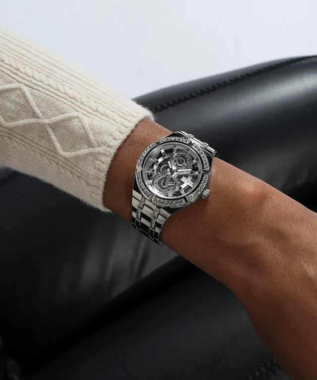GUESS GW0604L1 silver tone watch worn on wrist with cream cardigan