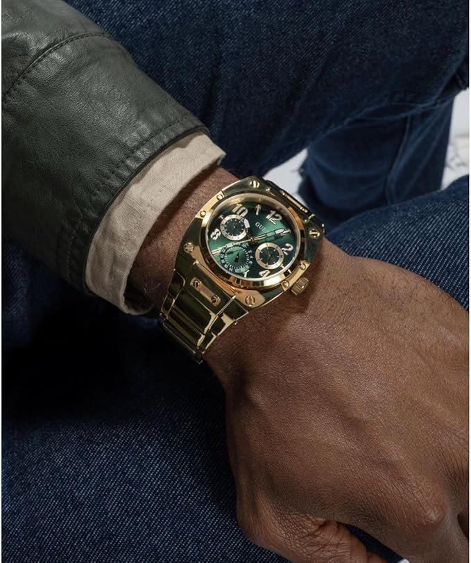On-wrist view of Guess GW0624G2 gold chronograph watch with green dial