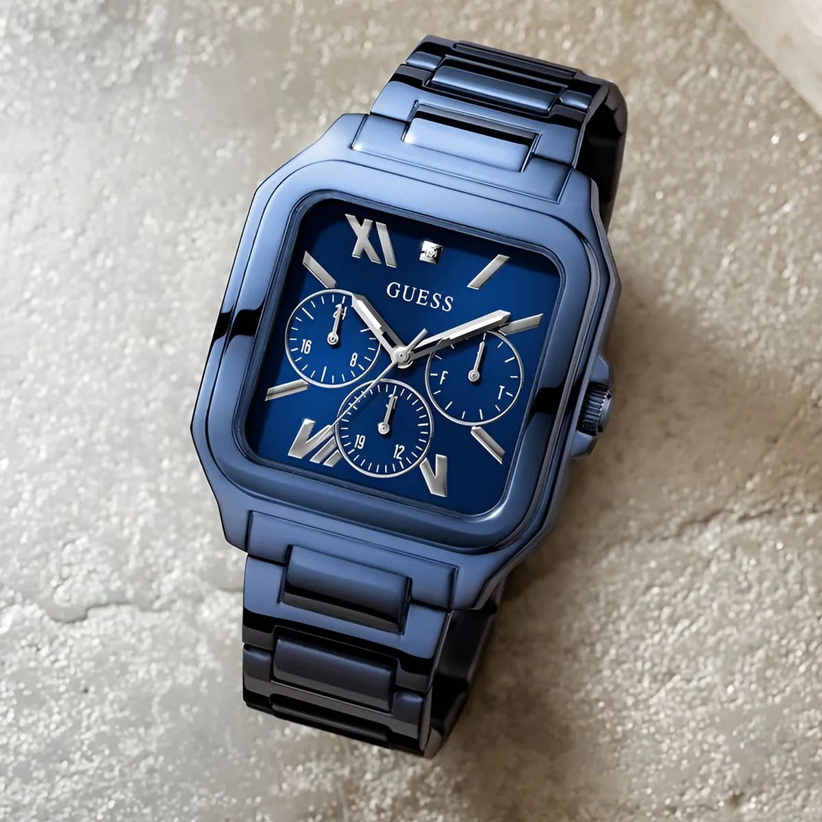 Guess GW0631G3 blue multifunction dress watch on neutral surface showing case and chronograph subdials
