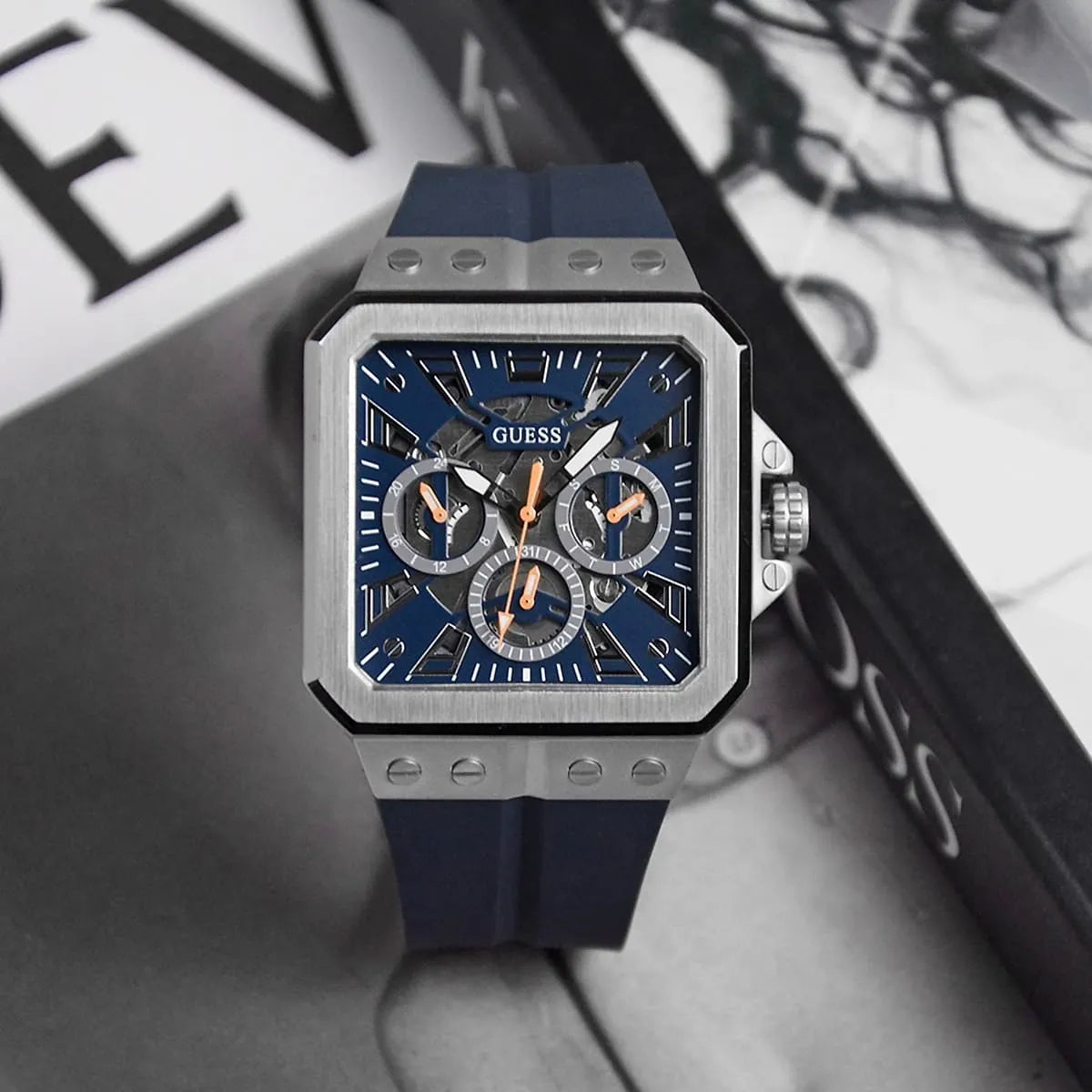 Guess GW0637G1 chronograph watch with navy dial on styled surface background