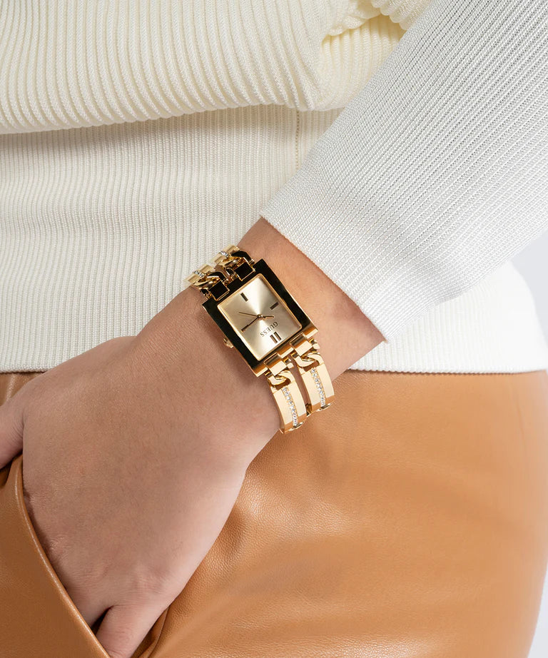 Guess GW0668L2 gold tone ladies watch worn on wrist with cream sweater