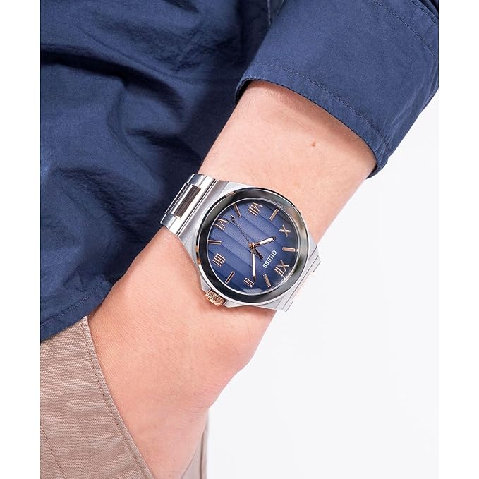 GUESS GW0789G4 watch on wrist showing blue dial with gold accents