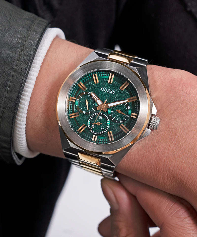 GUESS 2-tone watch on wrist with green dial and chronograph subdials