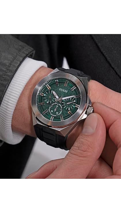 GUESS GW0799G3 multi-function watch on wrist showing green dial and subdials