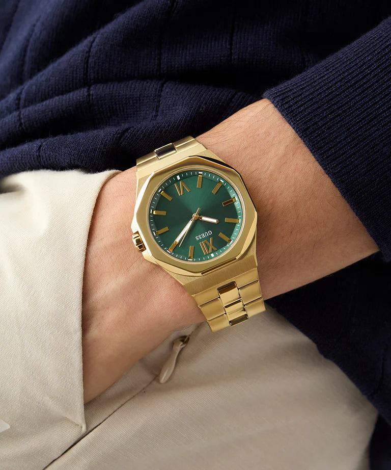GUESS GW0849G2 men's gold watch on wrist with green dial