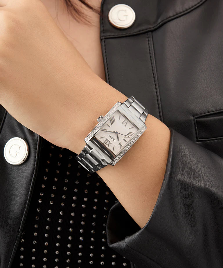 Guess crystal square watch worn on wrist with silver-tone case and bracelet