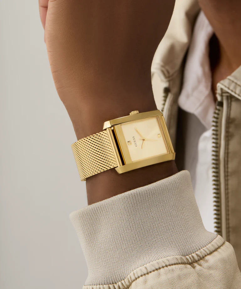 GUESS GW0898G1 gold watch worn on wrist with mesh band