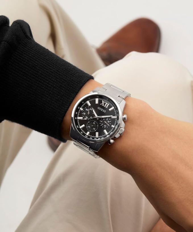 GUESS GW0900G1 watch worn on wrist with black dial and silver bracelet