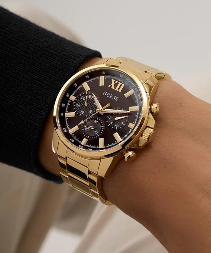 GUESS GW0900G3 gold chronograph watch worn on wrist with black dial