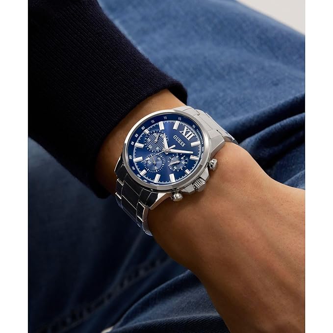 GUESS GW0900G4 chronograph watch worn on wrist with blue dial and silver bracelet