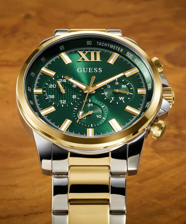 GUESS GW0900G5 dial detail with green face, gold hour markers, Roman numerals, and chronograph subdials