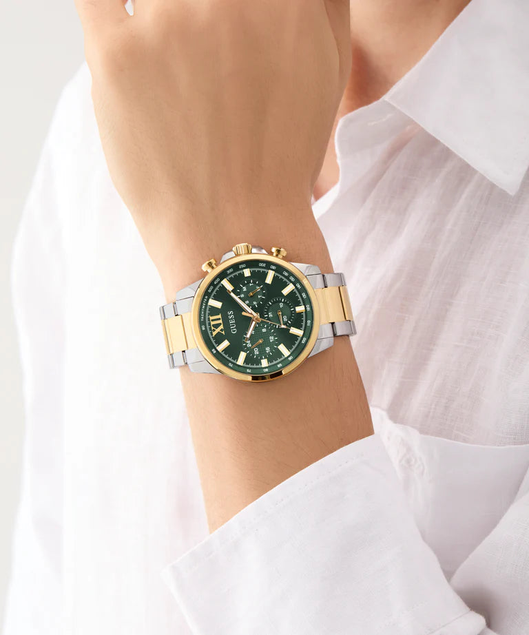 GUESS GW0900G5 men's chronograph watch worn on wrist with 2-tone metal bracelet and green dial