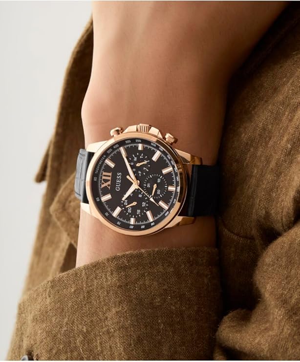 Guess GW0901G5 chronograph watch worn on wrist with black dial and gold-tone case