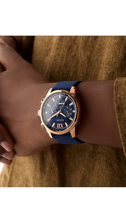 GUESS GW0913G1 chronograph watch worn on wrist with blue strap and rose gold case