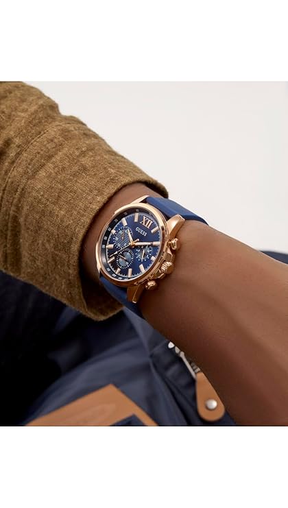 Wrist shot of GUESS GW0913G1 mens watch with blue dial and gold-tone case