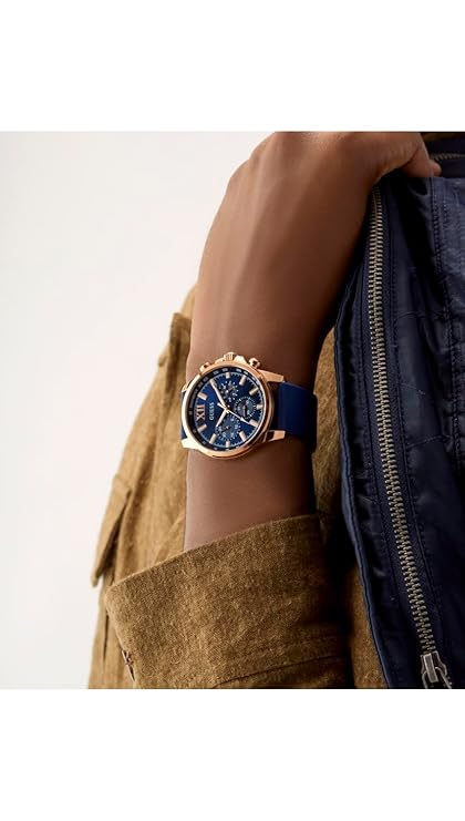 GUESS GW0913G1 watch on wrist displaying blue chronograph dial and rose gold bezel