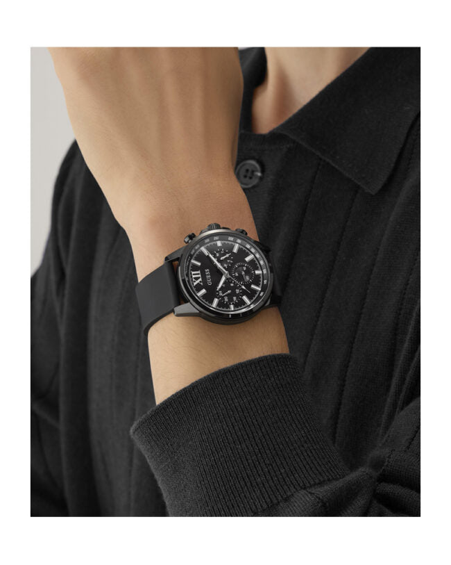 GUESS GW0913G3 chronograph watch worn on wrist with black silicone strap