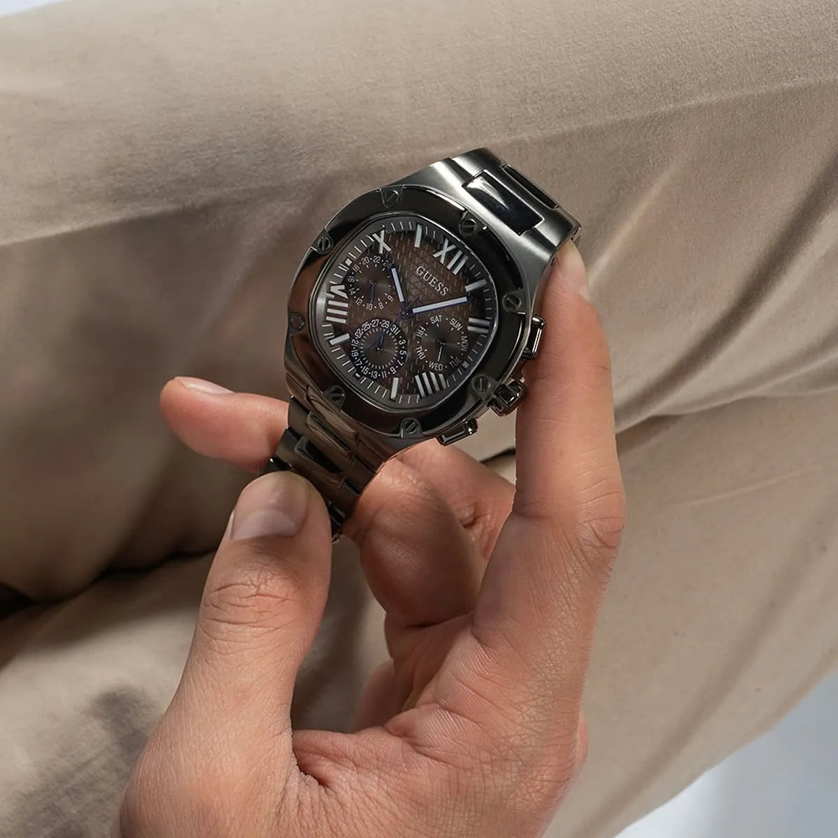 Guess Headline 42mm quartz watch held in hand displaying chronograph functionality