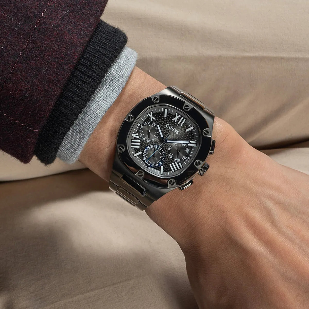 Guess Headline watch on wrist showing gunmetal case and subdials in casual setting