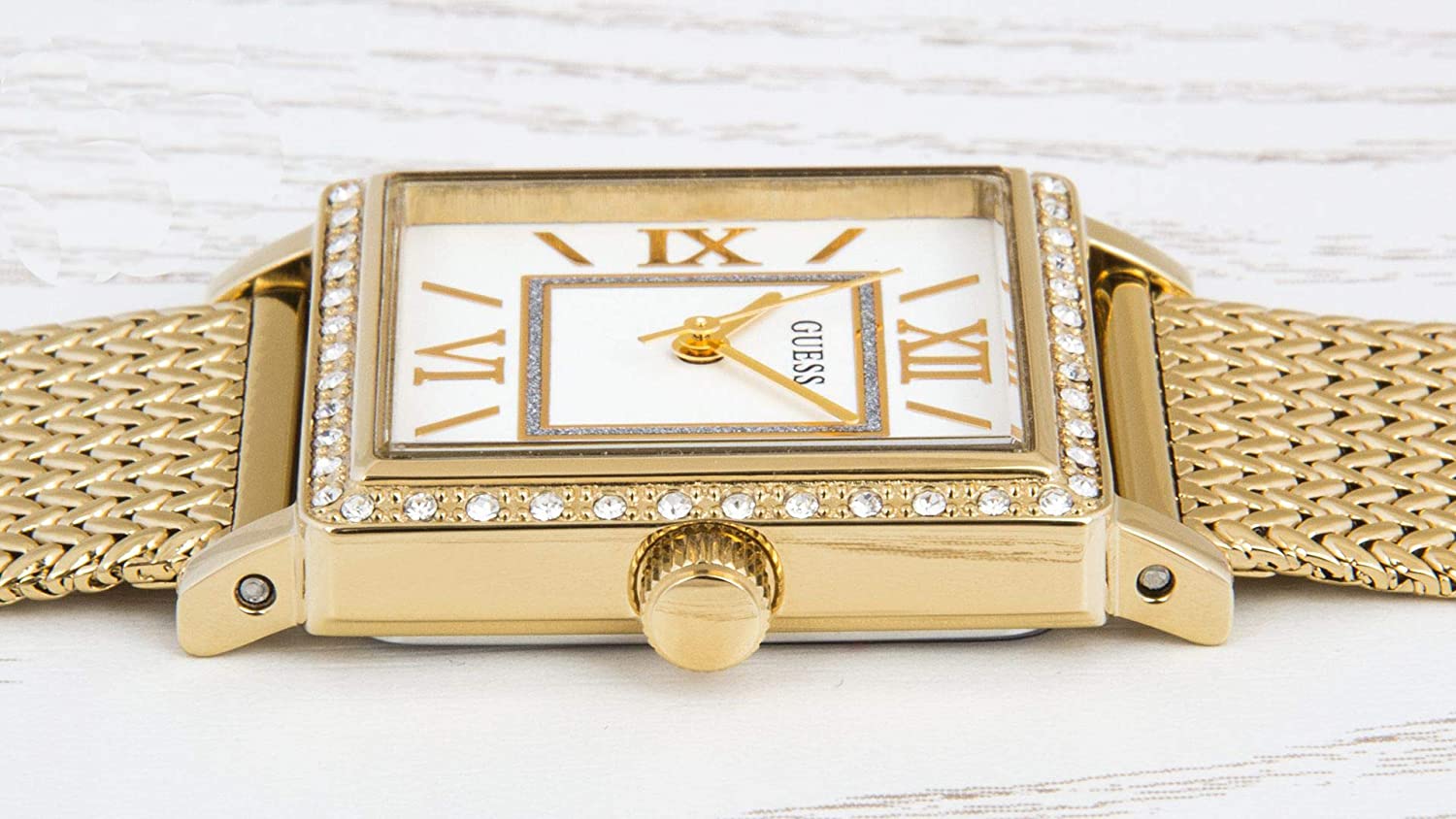Guess Highline watch worn on wrist with off-white dial and gold-tone textured mesh band