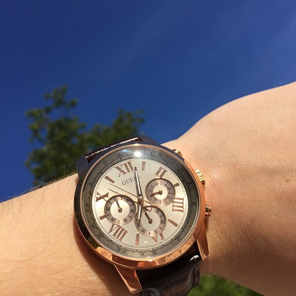 Guess Horizon W0380G4 watch worn on wrist showing rose gold case and silver dial