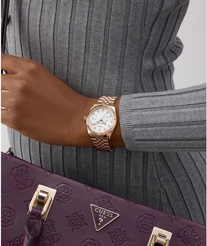 GUESS Jada rose gold watch worn on wrist with gray striped sleeve