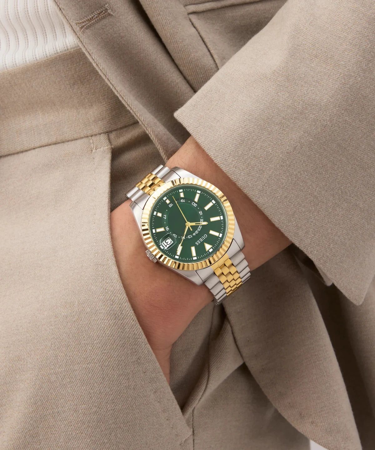 GUESS Jaden 2-tone watch on wrist with green dial and luminous hands visible