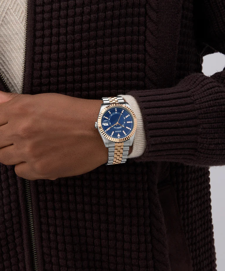 GUESS Jaden watch worn on wrist with blue dial and two-tone band visible